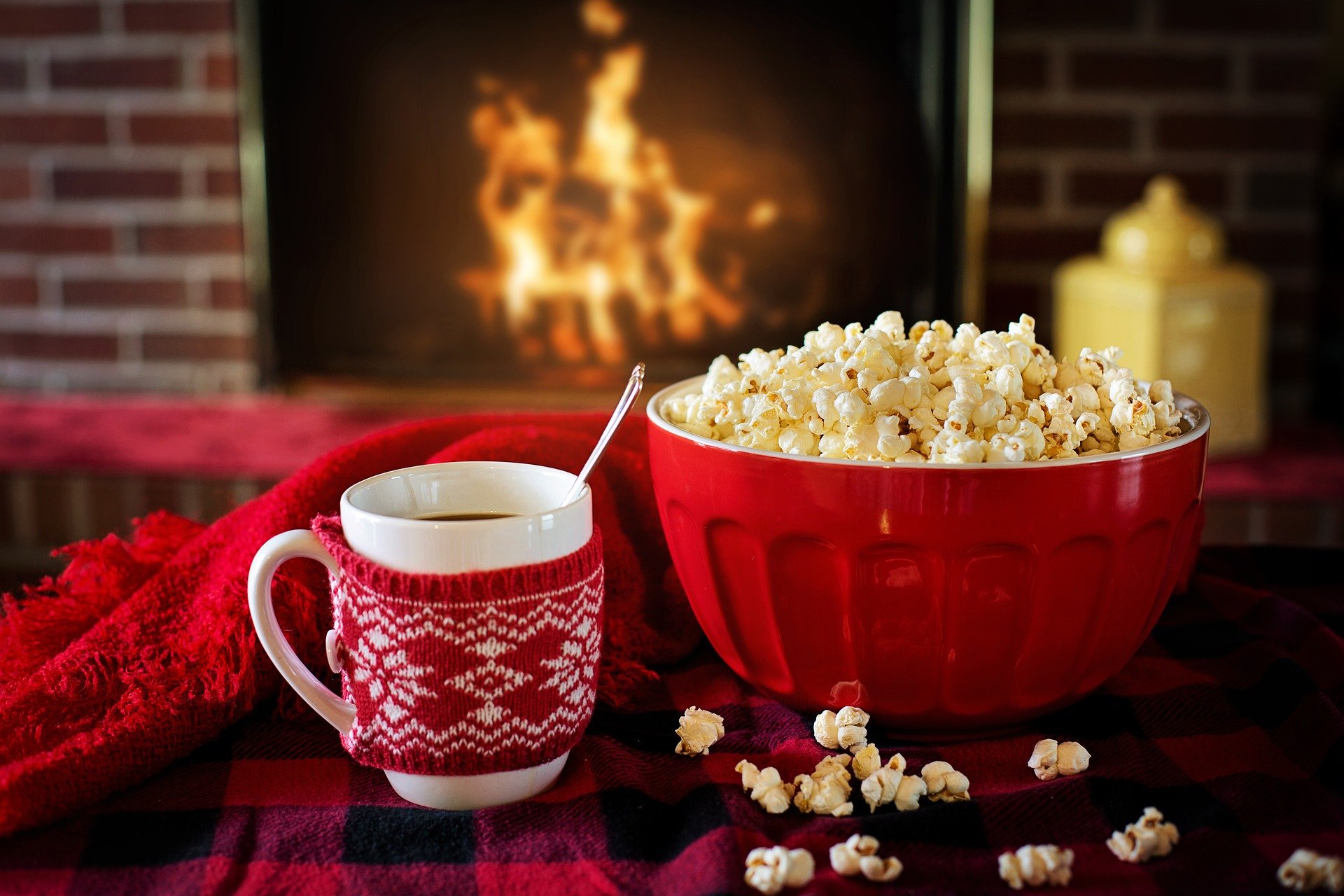 Hot cocoa and popcorn in front of a fireplace