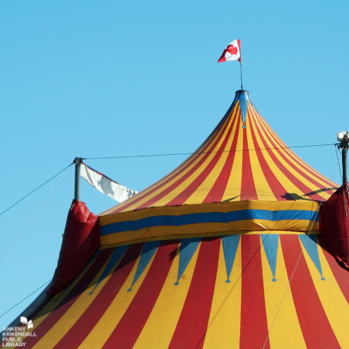The top of a gold and red striped circus tent