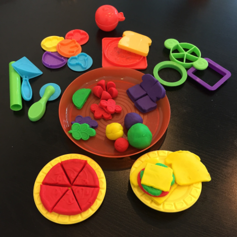 Black background image with various food items made out of playdough
