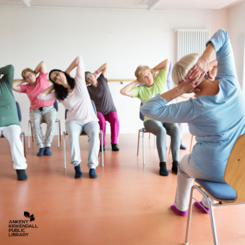 Photo of people doing chair yoga in a small room