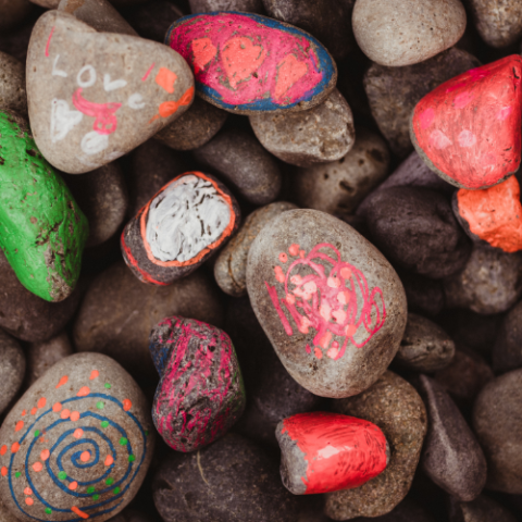 A pile of rocks painted with different designs