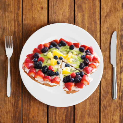 Sliced fruit pizza on a plate