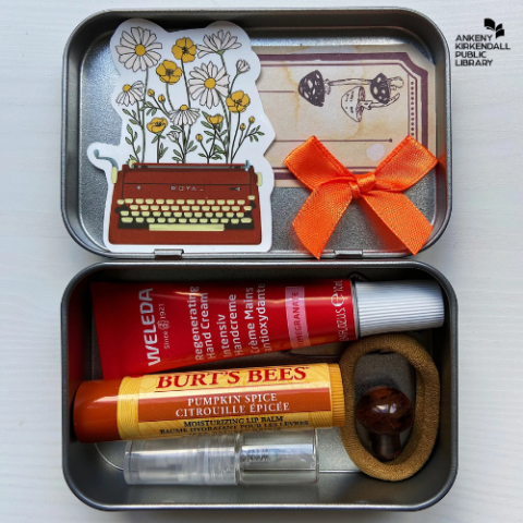 Altoids tin with stickers, ribon, lip gloss, lotion, hair ties, and hand sanitizer inside