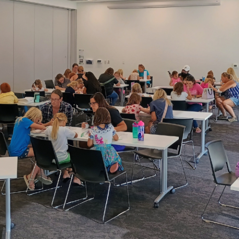 A group of people work on a craft. 