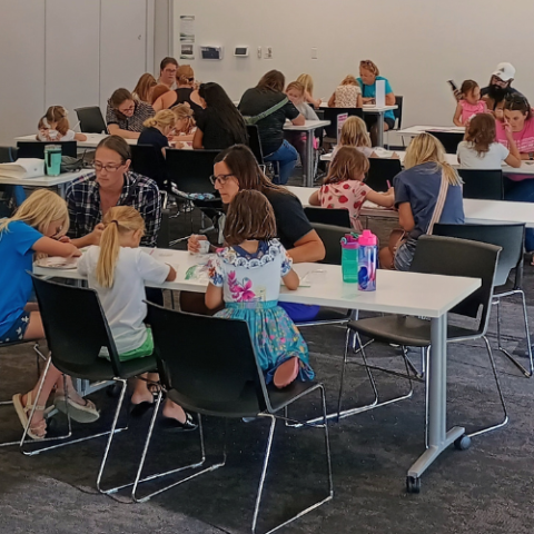 A group of people work on a craft. 