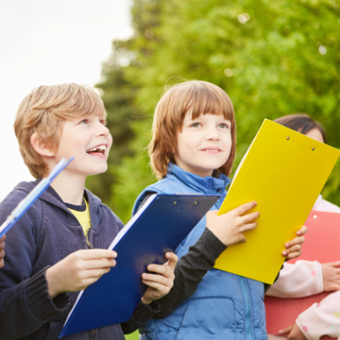 Children look for clues during a treasure hunt.
