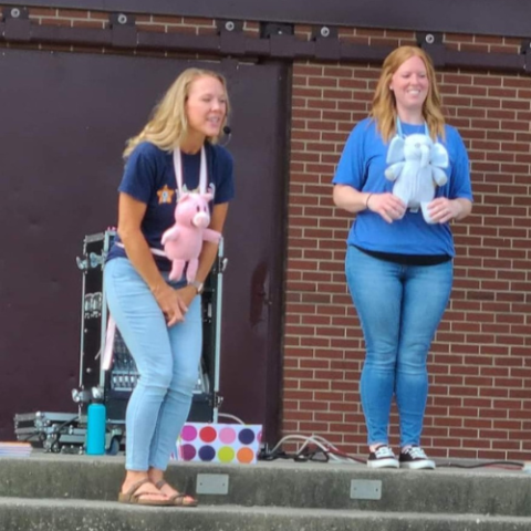 Librarians share a story time about an elephant and a pig. 