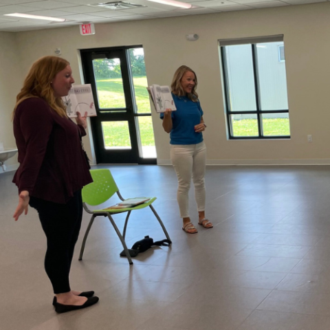Librarians read a picture book. 