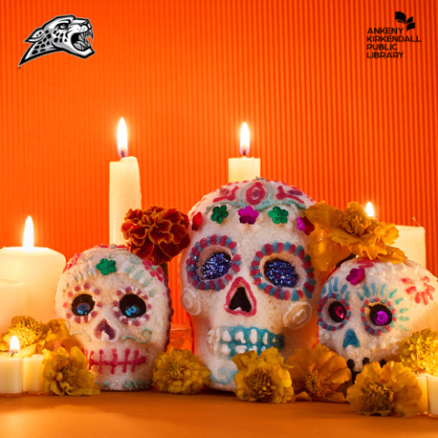 Three painted skulls with marigolds and lit candles surrounding them with an orange background and the Centennial Jaguars and Ankeny Kirkendall Public Library Logos