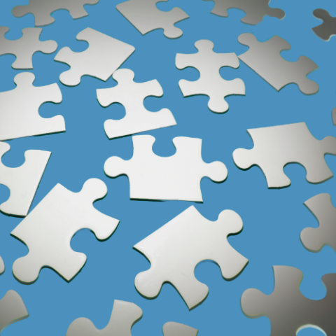 White puzzle pieces against a light blue background