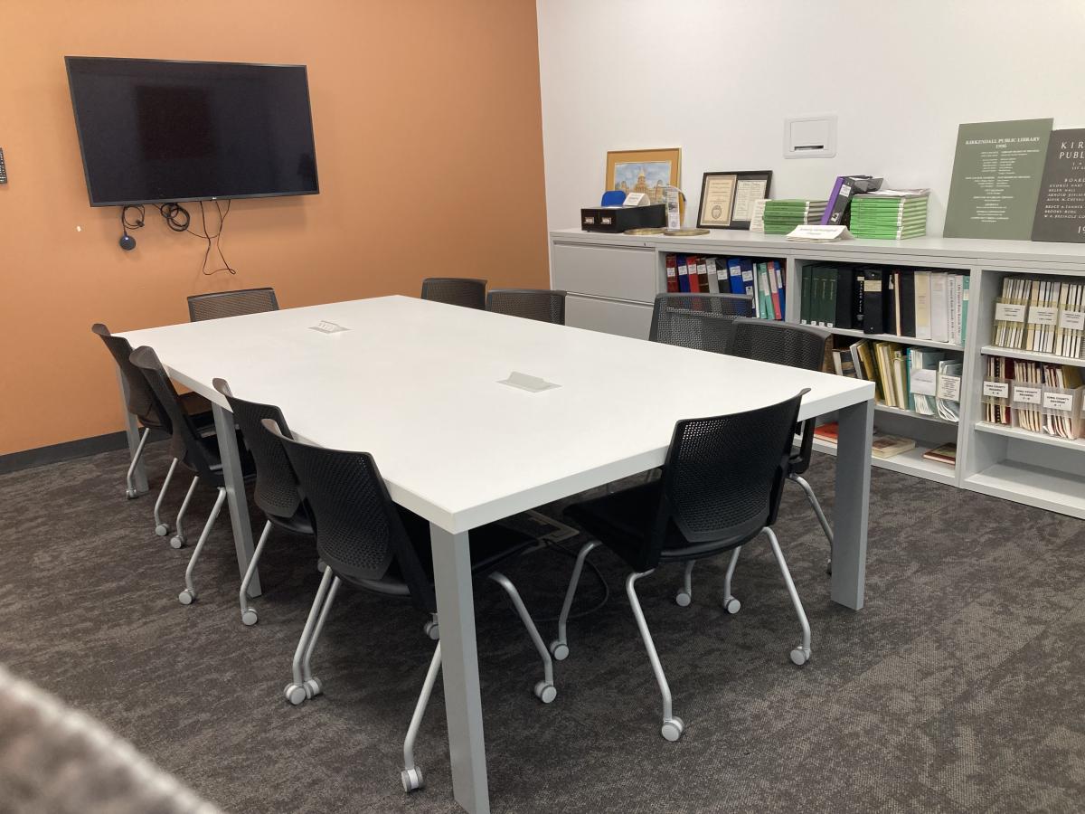 Image of Conference Room A with rectangular table, 10 chairs; mounted television