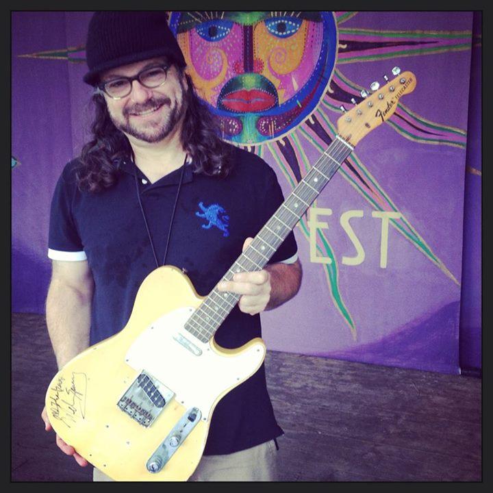 Photo of Joey Leone with a guitar