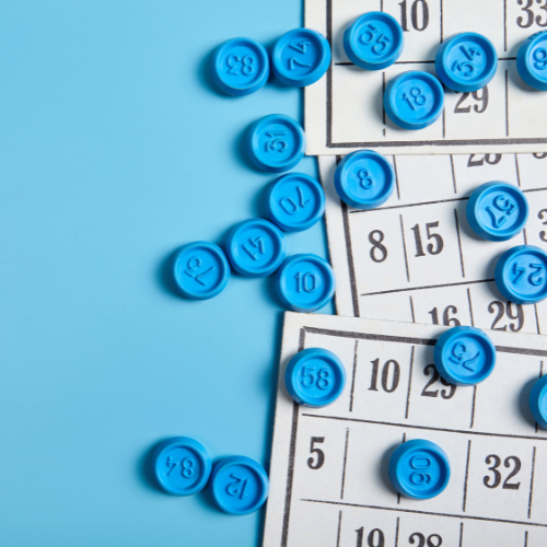 BINGO cards and markers against a blue background