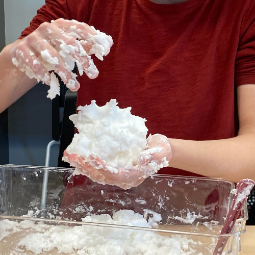 Close up of person playing with DIY snow