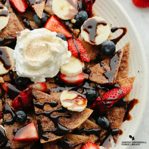 Cinnamon and sugar nachos with chocolate syrup, whipped cream, bananas, and strawberries