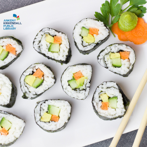 Tray of California roll sushi with carrots and wasabi on the side